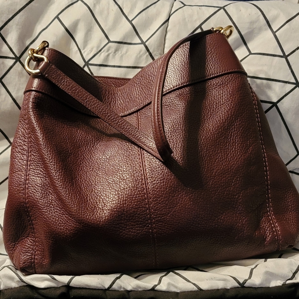Maroon/burgundy gently used Coach handbag. More pictures can be made upon reques